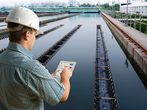 Man using tablet and software looking over drinking water area.